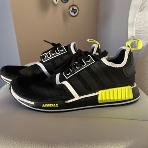 Adida NMD R1 in black, white, and neon green.